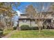 Exterior of a two-story townhouse showcasing mature trees and well-maintained lawn at 4211 The Oaks Dr, Raleigh, NC 27606