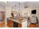 Open kitchen features a breakfast bar with a double sink and pendant lighting overlooking the living room at 43 Regulator Dr, Clayton, NC 27520