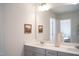 Bright bathroom features gray cabinets with dual sinks and a decorative vase at 5006 Tura St, Raleigh, NC 27610