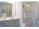 Modern bathroom featuring gray cabinets, glass shower, and ceramic tile floors at 5006 Tura St, Raleigh, NC 27610