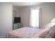 Bedroom featuring a window, TV, and floral quilt at 5006 Tura St, Raleigh, NC 27610