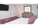 Comfortable bedroom features wood framed bed, dresser, and a wall-mounted television at 5006 Tura St, Raleigh, NC 27610