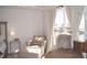 Bedroom area features a plush chaise lounge, large window, and accent furniture at 5006 Tura St, Raleigh, NC 27610