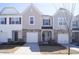 Well-maintained townhome featuring stone accents, neutral siding, and attached one car garage at 5006 Tura St, Raleigh, NC 27610