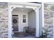 Charming covered front porch adorned with a festive wreath and cozy seating at 5006 Tura St, Raleigh, NC 27610