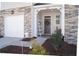 Covered front porch with seating and decor next to a one car garage at 5006 Tura St, Raleigh, NC 27610