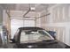 Clean and organized garage featuring an open door and car at 5006 Tura St, Raleigh, NC 27610