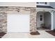 Attached one car garage with stone accents and cozy front porch with seating area at 5006 Tura St, Raleigh, NC 27610
