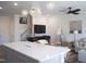 Open-concept design shows a living space with modern chandelier and view of the stairs and living room at 5006 Tura St, Raleigh, NC 27610