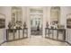 Beautifully decorated lobby with matching mirrored consoles and floral displays at 5006 Tura St, Raleigh, NC 27610