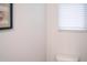 Neutral colored powder room featuring a close up of the toilet and window at 5006 Tura St, Raleigh, NC 27610