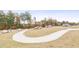 Scenic walking path winds through a park-like setting with mature trees and decorative rock features at 5006 Tura St, Raleigh, NC 27610