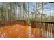Wooden deck with railings overlooking a treed backyard at 6712 Stepherly Way, Holly Springs, NC 27540