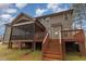 Home exterior featuring a backyard, deck, screened porch and wood siding at 6712 Stepherly Way, Holly Springs, NC 27540