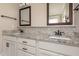 Bathroom featuring dual vanities with granite countertops, mosaic backsplash and framed mirrors at 6712 Stepherly Way, Holly Springs, NC 27540