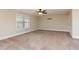 Spacious bedroom featuring neutral walls, plush carpet, and a ceiling fan with light at 6712 Stepherly Way, Holly Springs, NC 27540