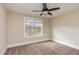 Bedroom with neutral walls, carpet, ceiling fan, and window bringing in natural light at 6712 Stepherly Way, Holly Springs, NC 27540