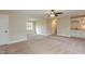 Open bonus room with carpet, built in bar and natural light from the window at 6712 Stepherly Way, Holly Springs, NC 27540