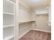 Walk-in closet with custom shelving and hanging rods at 6712 Stepherly Way, Holly Springs, NC 27540