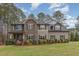 Charming two-story home featuring a blend of stone and siding, accented by well-manicured landscaping and a lush green lawn at 6712 Stepherly Way, Holly Springs, NC 27540