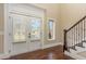 Inviting foyer with hardwood floors, bright windows and staircase at 6712 Stepherly Way, Holly Springs, NC 27540