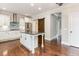 Modern kitchen with stainless steel appliances, a center island with granite countertops, and a barn door at 6712 Stepherly Way, Holly Springs, NC 27540