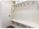 Mudroom with built-in bench, coat hooks, and storage cubbies at 6712 Stepherly Way, Holly Springs, NC 27540