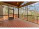Covered screened porch with wood flooring and wooded view at 6712 Stepherly Way, Holly Springs, NC 27540