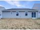 Wide backyard with a sliding glass door to the exterior and gray siding on the home at 737 Little Patch St, Zebulon, NC 27597