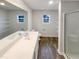 Bathroom featuring a modern vanity with white countertop, sleek fixtures, and spacious walk-in shower at 737 Little Patch St, Zebulon, NC 27597