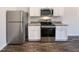 Efficient kitchen featuring stainless steel appliances, white cabinets and dark countertop for a modern aesthetic at 737 Little Patch St, Zebulon, NC 27597