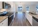 Modern kitchen with stainless steel appliances, sleek countertops and hardwood floors at 737 Little Patch St, Zebulon, NC 27597