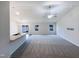 Bright open-concept living room with neutral paint, plush carpeting, and ample natural light at 737 Little Patch St, Zebulon, NC 27597