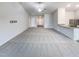 Open-concept living space with carpet and a view of kitchen with granite countertops at 737 Little Patch St, Zebulon, NC 27597