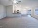 Expansive living room showcasing abundant natural light and seamless transition to an open kitchen at 737 Little Patch St, Zebulon, NC 27597