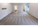 Spacious primary bedroom with neutral walls, carpet, and adjacent ensuite bathroom and walk-in closet at 737 Little Patch St, Zebulon, NC 27597