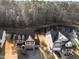 An aerial view of two beautiful homes with well-maintained yards and a serene pond in a desirable neighborhood at 7520 Channery Way, Raleigh, NC 27616