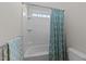 Bright bathroom featuring a tub with a shower and a blue-patterned shower curtain for a stylish touch at 7520 Channery Way, Raleigh, NC 27616