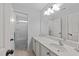 Well-lit bathroom features white vanity, neutral walls, and a combined shower/tub for a clean and practical design at 7520 Channery Way, Raleigh, NC 27616