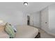 Bedroom featuring two entryways, a bed with decorative pillows, and neutral walls and carpet at 7520 Channery Way, Raleigh, NC 27616