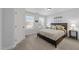 Comfortable bedroom featuring two windows, a bed with decorative pillows, and neutral walls and carpet at 7520 Channery Way, Raleigh, NC 27616