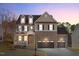 Beautiful two-story home with a well-manicured lawn and three-car garage at 7520 Channery Way, Raleigh, NC 27616