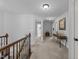 A spacious upstairs hallway with neutral colors, a wood banister, and decorative accents creates an inviting transition space at 7520 Channery Way, Raleigh, NC 27616