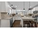 Open kitchen featuring white cabinets, stainless steel appliances, and granite countertops at 7520 Channery Way, Raleigh, NC 27616