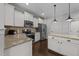 Modern kitchen with stainless steel appliances, granite countertops, and ample cabinet space at 7520 Channery Way, Raleigh, NC 27616