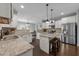 Spacious kitchen with white cabinets, stainless steel appliances, granite countertops, and an island with seating at 7520 Channery Way, Raleigh, NC 27616