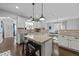 Bright kitchen with granite countertops, stainless steel appliances, and an island with barstool seating at 7520 Channery Way, Raleigh, NC 27616