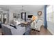 Bright living room featuring a fireplace, stylish furniture, hardwood floors and a modern chandelier at 7520 Channery Way, Raleigh, NC 27616