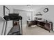 Office with a desk, treadmill, and a window offering natural light, perfect for a home workspace at 7520 Channery Way, Raleigh, NC 27616