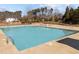 A refreshing community pool area featuring a pool with marked depth, wheelchair lift and a well-maintained deck at 7520 Channery Way, Raleigh, NC 27616